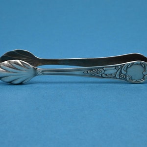 Silver-plated sugar tongs in a rococo pattern