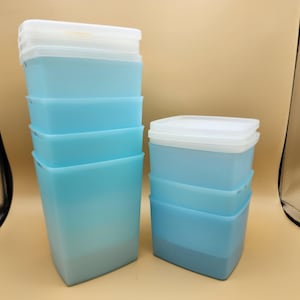 May include: Stackable plastic storage containers in blue and white. The containers are square and have a frosted finish. There are six containers in total, with five blue containers and one white container.
