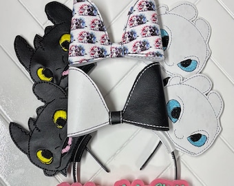 May include: A collection of headbands featuring character designs. The headbands include black and white bows, and character cutouts. One bow has a print of characters. The text "Valedrian Baby Stuff & more" is visible on a pink background.