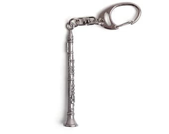 May include: Silver-toned metal keychain featuring a detailed miniature clarinet.