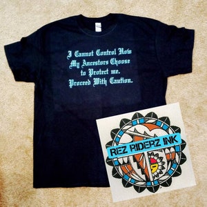 May include: A black t-shirt with a turquoise blue inscription that reads "I Cannot Control How My Ancestors Choose to Protect me. Proceed With Caution." The t-shirt is next to a white square with a colorful Native American design and the text "REZ RIDERZ INK".