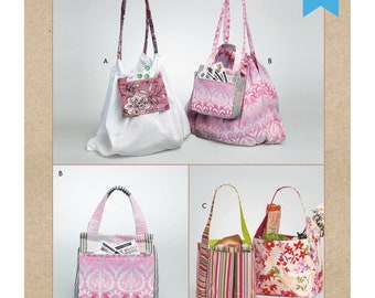 May include: Image of a sewing pattern for grocery totes. The pattern features four different tote bag designs in various fabrics, including floral, striped, and patterned textiles. The text "kwik sew" and "grocery totes" are visible.