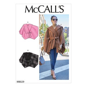 May include: McCall's sewing pattern featuring three cape designs. One cape is pink with a tie closure, another is a black and gray plaid with a tie, and the third is a brown hooded cape with a belt. The pattern number is M8029.