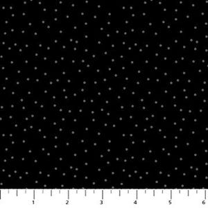 May include: Black fabric with a pattern of small, scattered, light gray dots. The dots are evenly spaced across the surface. A ruler is at the bottom of the image, showing measurements in inches.