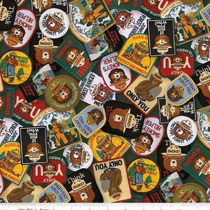May include: A collection of Smokey Bear patches in various shapes and sizes. The patches feature Smokey Bear in different poses, along with text like "Prevent Forest Fires" and "Only You". The color palette includes brown, green, red, and yellow.