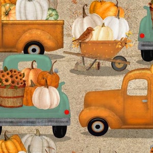 May include: A vintage teal pickup truck with a bed full of pumpkins and gourds. The truck is parked next to a yellow pickup truck with a bed full of pumpkins and gourds. There is also a wheelbarrow with pumpkins and gourds in the background.