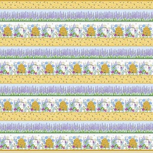 May include: A repeating pattern of beehives, lavender, and flowers on a white background. The beehives are yellow and brown with a white roof. The lavender is purple and the flowers are pink, blue, and yellow. The background is white with a light blue stripe.