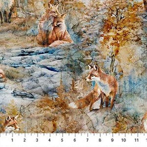 May include: Fabric with a watercolor-style forest scene featuring several foxes. The foxes have reddish-brown fur and are set against a backdrop of trees and rocks in shades of blue, brown, and gold. A ruler is at the bottom.