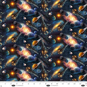 May include: A fabric pattern featuring a repeating space scene. The design includes planets, galaxies, rockets, and stars in shades of blue, orange, and purple. The image has a ruler at the bottom with measurements in inches.