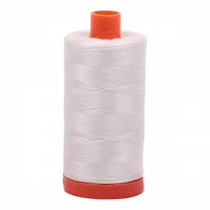 May include: A spool of white thread with an orange plastic bobbin.