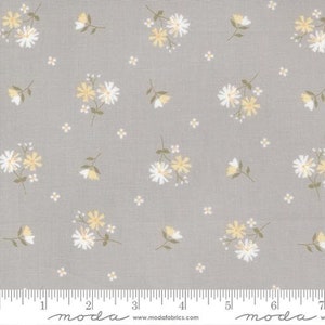 May include: A gray fabric with a white and yellow floral pattern. The flowers are small and scattered throughout the fabric.