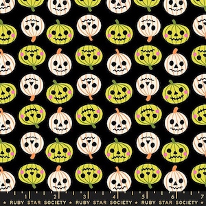 May include: A black fabric featuring a repeating pattern of stylized jack-o'-lanterns in lime green and white. Each pumpkin has a unique carved face with pink cheeks. A ruler at the bottom shows 7 inches, with the text Ruby Star Society.