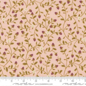 May include: Pink fabric with a repeating pattern of small brown vines and pink berries. The fabric has a white ruler with the word "moda" printed on it.