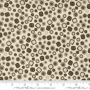 May include: Fabric with a repeating pattern of brown buttons in various shapes and sizes on a cream background. The buttons include round and square designs, with two or four holes. A ruler is at the bottom.