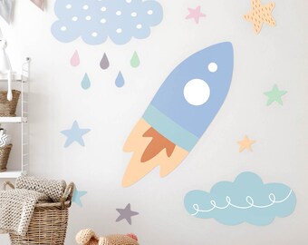 May include: A set of blue and orange rocket, cloud, and star wall decals for a nursery or child's room. The decals are perfect for adding a whimsical touch to any space.