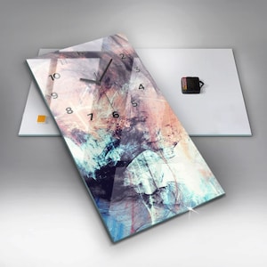 May include: A rectangular glass clock with a colorful abstract design. The clock face has black numbers and hands.