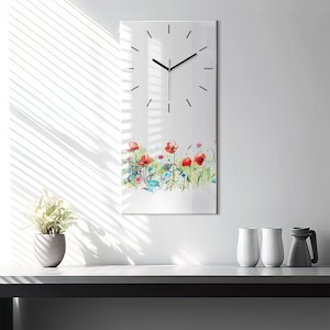 May include: A white clock with black hands and a watercolor design of red poppies and other flowers at the bottom. The clock is on a white wall.