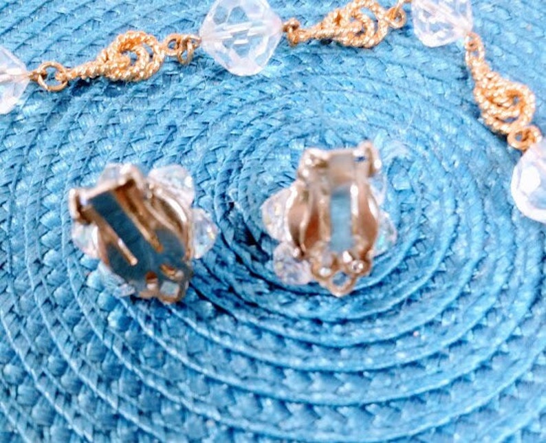 May include: A pair of silver clip-on earrings with clear crystal accents. The earrings have a simple design and are perfect for everyday wear.