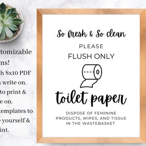 May include: A white sign with a black border and a gold frame. The sign says "So fresh & So clean" and "PLEASE FLUSH ONLY". There is a black and white illustration of a toilet paper roll. The sign also says "toilet paper" and "DISPOSE OF FEMININE PRODUCTS, WIPES, AND TISSUE IN THE WASTEBASKET".