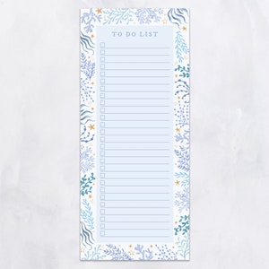 May include: A rectangular To Do List notepad with a light blue background. The notepad is framed with a watercolor design of blue and teal sea plants, coral, and gold stars. The words "TO DO LIST" are printed at the top.