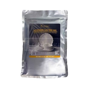 May include: A silver bag of Re-Design Casting Mix. The label features the text "REDESIGN CASTING MIX" and "REDISEÑO DE LA MEZCLA DE CASTING". The net weight is 2.2 LB / 1KG / 35.2 OZ. The bag also shows a casting time of 30 minutes.