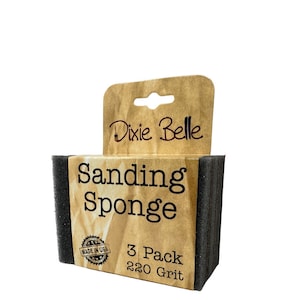 May include: A package of three black sanding sponges with a brown paper label that says "Dixie Belle Sanding Sponge 3 Pack 220 Grit" and a "Made in USA" sticker.