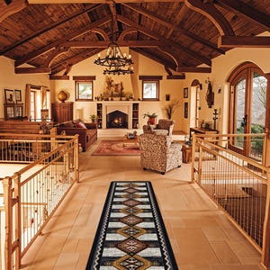 May include: A long, rectangular runner rug featuring a repeating geometric diamond pattern in shades of black, white, tan, and rust orange, bordered by a thick black frame with a white zigzag line detail running along the entire outer edge.
