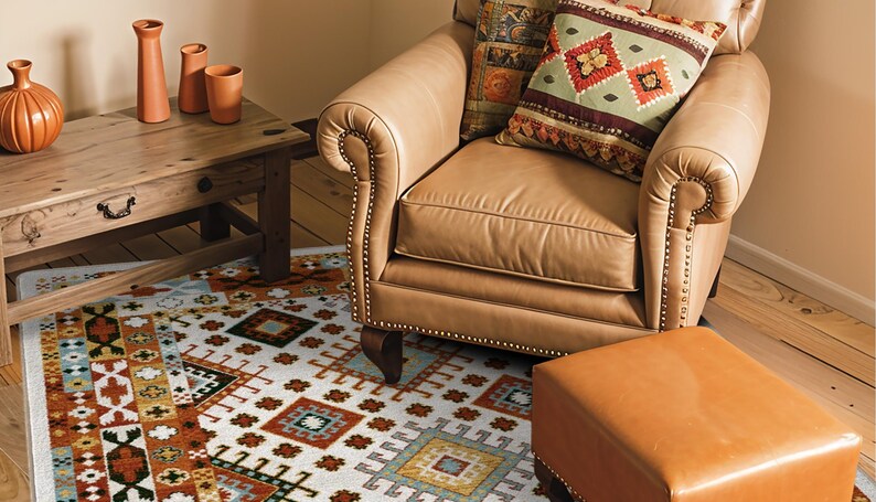 May include: A tan leather armchair with nailhead trim, a matching leather ottoman, and a patterned area rug featuring geometric shapes in orange, blue, and white. A wooden side table holds four terracotta-colored vases of varying heights.