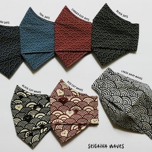 May include: A set of 10 fabric face masks with different patterns. The patterns include indigo dots, teal dots, cherry red dots, black dots, black cat waves, red cat waves, and large navy waves. The masks are all made of cotton fabric and have a sewn-in nose wire. The masks are all folded and laid out on a white surface. The text "SEIGAIHA WAVes" is printed on the bottom of the image.