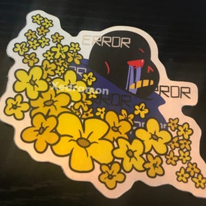May include: A black and blue cartoon character with a red eye and a tear, surrounded by yellow flowers. The character has the word "ERROR" written on its head and chest.