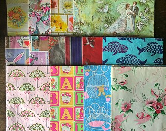 May include: A collection of 12 different patterned wrapping paper sheets. The patterns include a wedding scene, a baby carriage, a fish, a bunny, a floral design, and more.