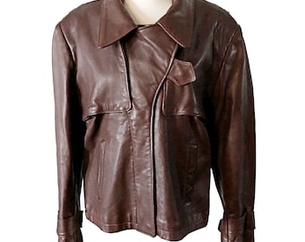 May include: A brown leather jacket with a  collar and a zipper closure. The jacket has two pockets on the front and a belt at the waist.