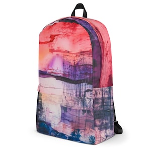 May include: A pink, purple, and blue abstract watercolor print backpack. The backpack has a black zipper and adjustable straps.
