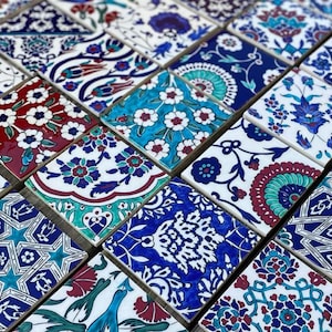 May include: A collection of colorful ceramic tiles with intricate floral and geometric patterns in shades of blue, white, red, and green. The tiles are arranged in a mosaic pattern.