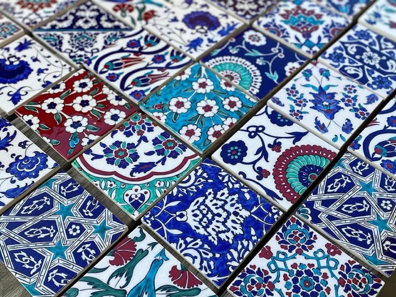 May include: A collection of colorful ceramic tiles with intricate floral and geometric patterns in shades of blue, white, red, and green. The tiles are arranged in a mosaic pattern.
