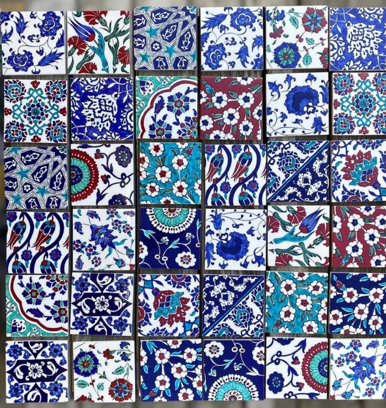 May include: A collection of 25 square ceramic tiles with intricate floral and geometric patterns in shades of blue, white, red, and green. The tiles are arranged in a grid pattern.