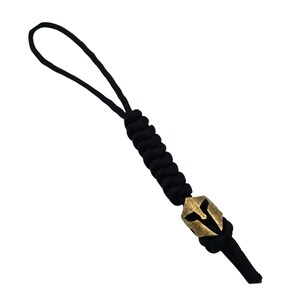 May include: Black paracord keychain with a gold-colored Spartan helmet charm.