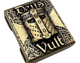 May include: A gold-toned metal charm with a knight's helmet and the words "Deus Vult" in a stylized font.