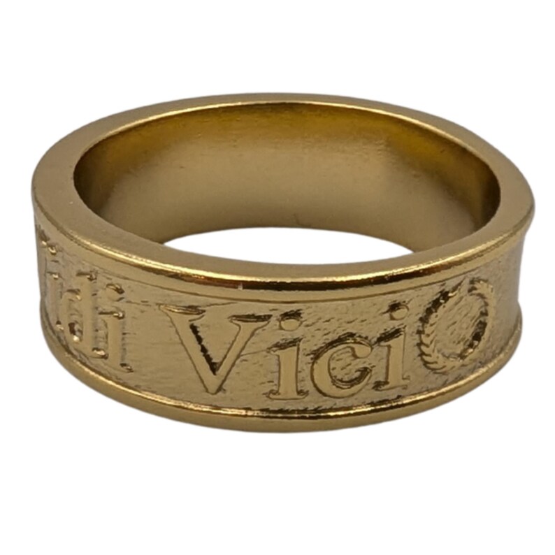 May include: A gold-toned metal band ring featuring a textured surface with the embossed text Veni Vidi Vici. The ring has a smooth, polished interior and a slightly raised rim along the top and bottom edges, creating a classic, uniform circular shape.