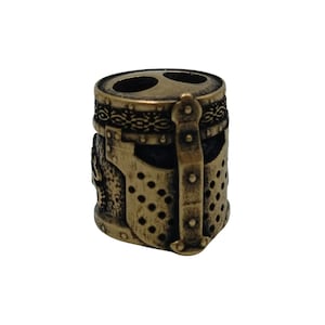 May include: A bronze-colored metal bead shaped like a knight's helmet with a chainmail design and a decorative band around the top.