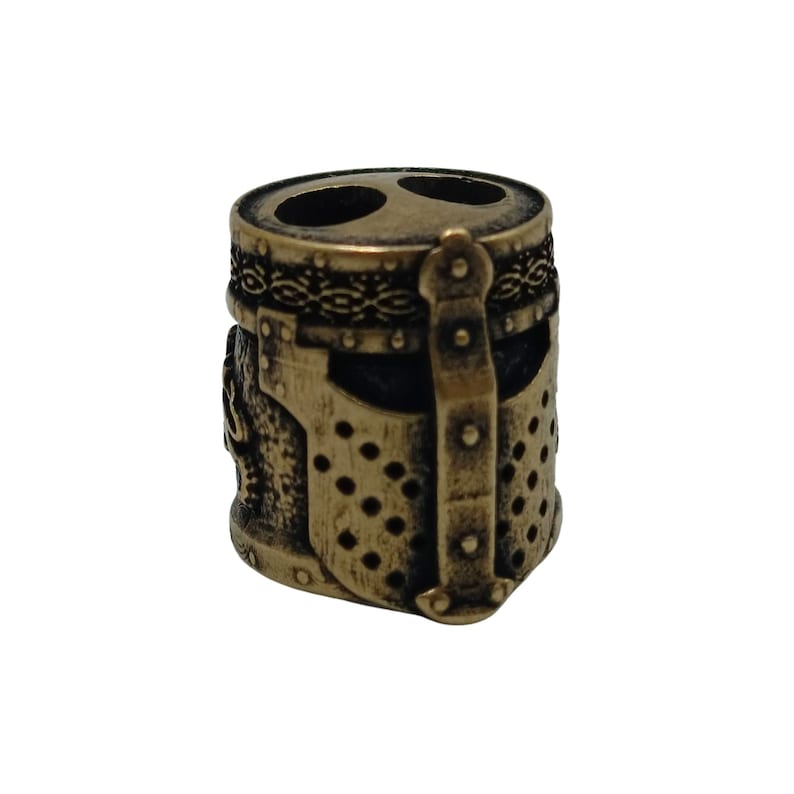 May include: A bronze-colored metal bead shaped like a knight's helmet with a chainmail design and a decorative band around the top.