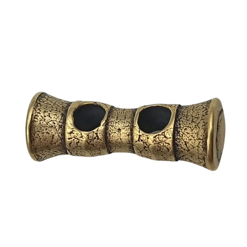 May include: Gold-toned metal toggle with a textured surface and two round holes. The toggle is designed to resemble a piece of bamboo.