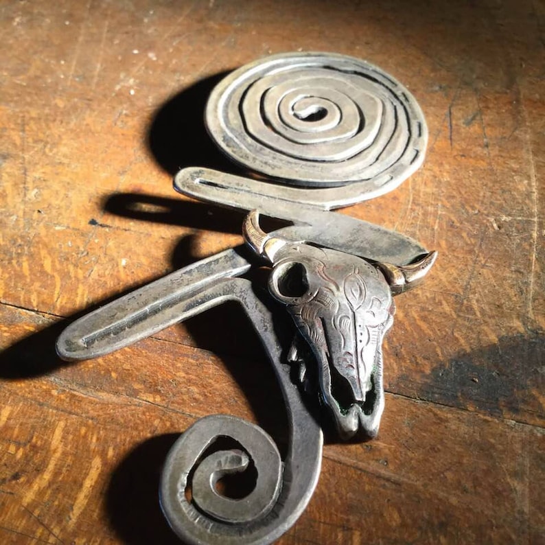 silver and brass brooch