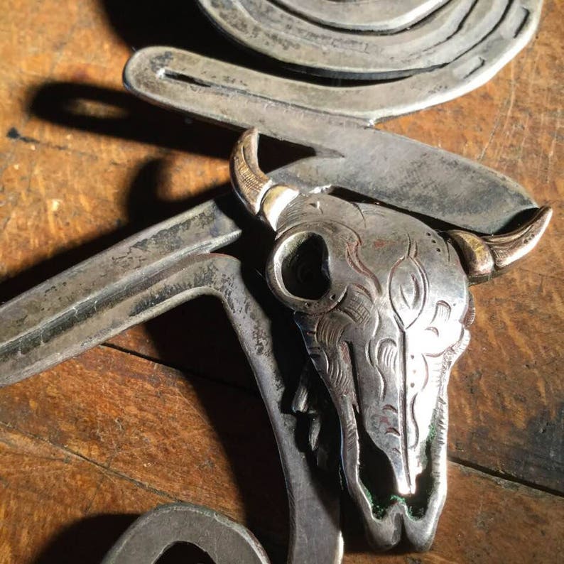 silver and brass brooch