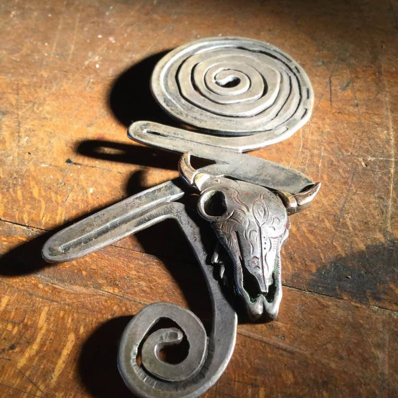 silver and brass brooch