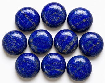 May include: Nine circular, polished lapis lazuli cabochons arranged in a cluster. Each stone features a deep royal blue base color with natural, shimmering gold-colored pyrite inclusions scattered across the smooth, rounded surfaces.