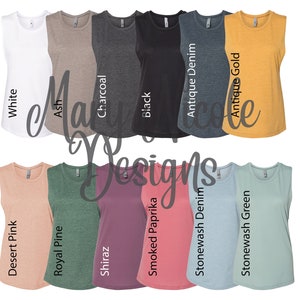 May include: A variety of sleeveless shirts in different colors, including white, ash, charcoal, black, antique denim, antique gold, desert pink, royal pine, shiraz, smoked paprika, stonewash denim, and stonewash green.