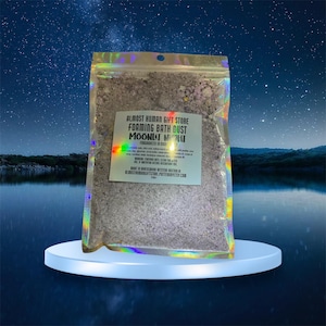 May include: A clear plastic bag filled with a white bath dust product. The bag has a label that reads "Almost Human Gift Store Foaming Bath Dust Moonlit Night Fragranced in Soy".