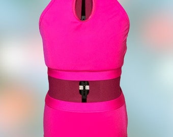 May include: A hot pink dance leotard with a high neck and a keyhole cutout in the front. The leotard has a matching hot pink skirt with a high waist.