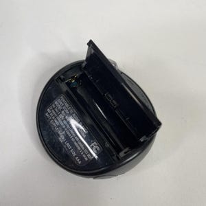 May include: Black Sony portable IC audio player with an open battery compartment. The player has the text "PORTABLE IC AUDIO PLAYER" and "SONY CORP. MADE IN CHINA" printed on it. The battery compartment is designed for AAA batteries.